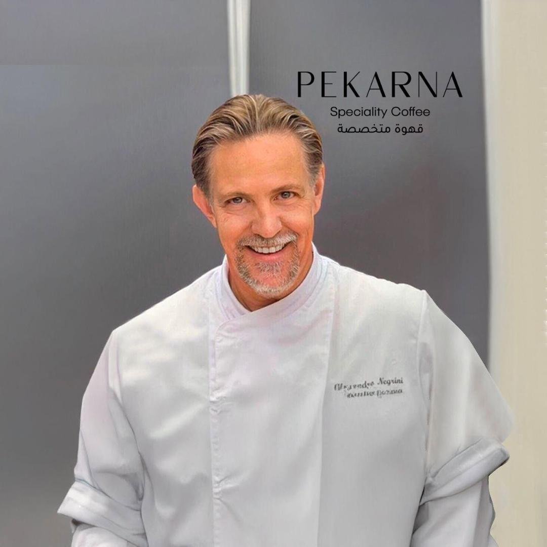 Chef Alessandro Negrini in front of Pekarna Specialty Coffee sign in Jeddah